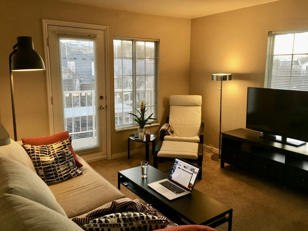 Bright, well-furnished vacation rental living room with modern amenities that support premium pricing
